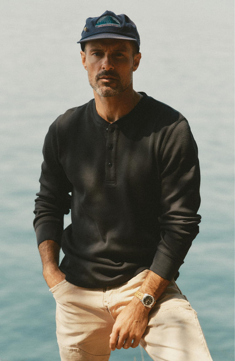 fit model posing in The Organic Cotton Waffle Henley in Faded Black