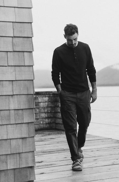 fit model walking wearing The Organic Cotton Waffle Henley in Faded Black