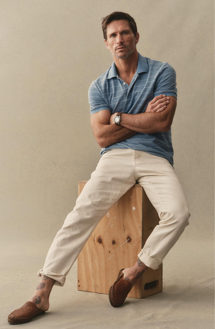 fit odel posing in The Pacific Polo in Washed Indigo Pique Stripe