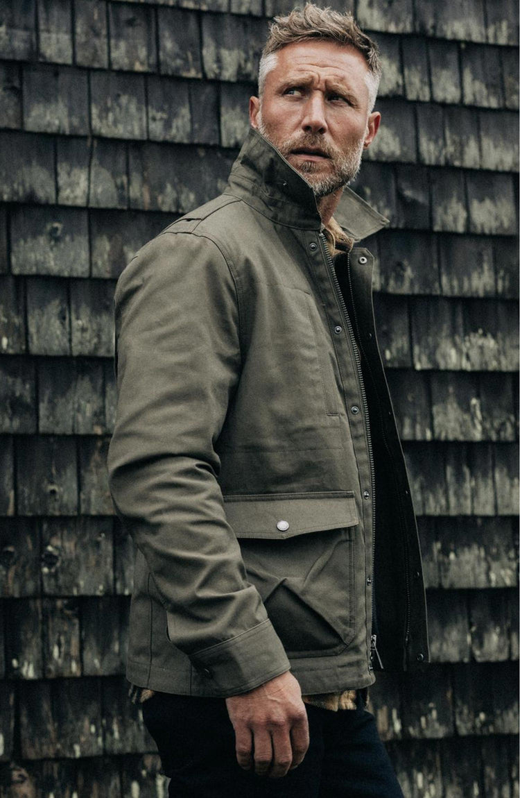 fit model posing in The Pathfinder Jacket in Fatigue Olive Dry Wax