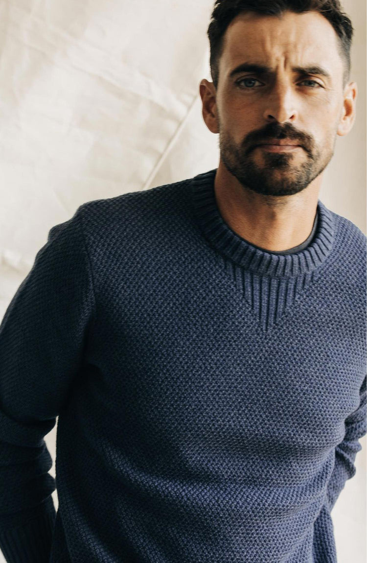 fit model posing in The Russell Sweater in Heather Blue