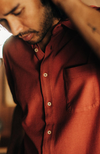 fit model posing in the short sleeve california in red clay pique