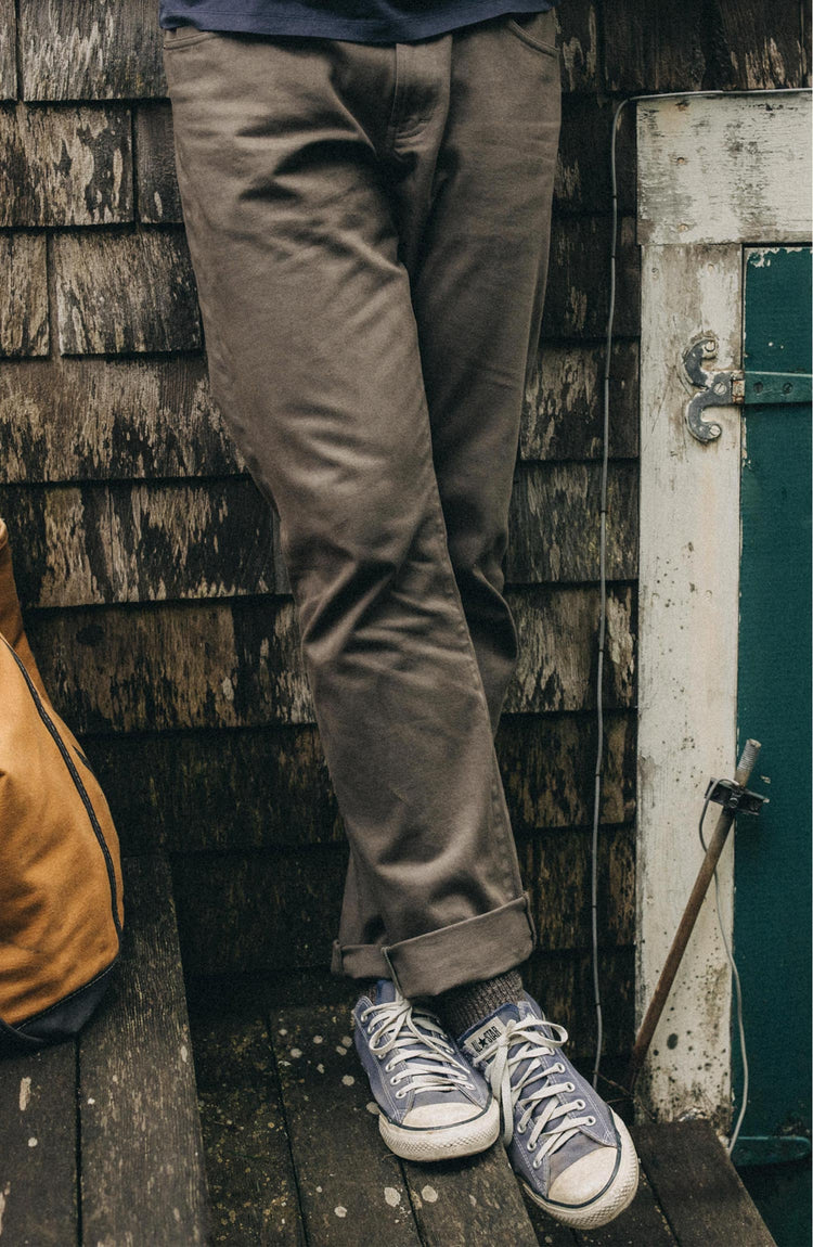 fit model posing in The Slim All Day Pant in Fatigue Olive Selvage Denim