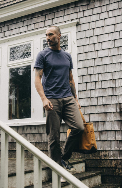 fit model walking down the stairs in The Slim All Day Pant in Fatigue Olive Selvage Denim