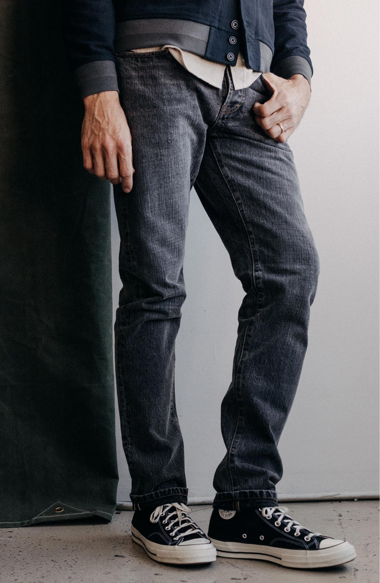 Model wearing The Slim Jean in Black 1-Year Wash Selvage Denim