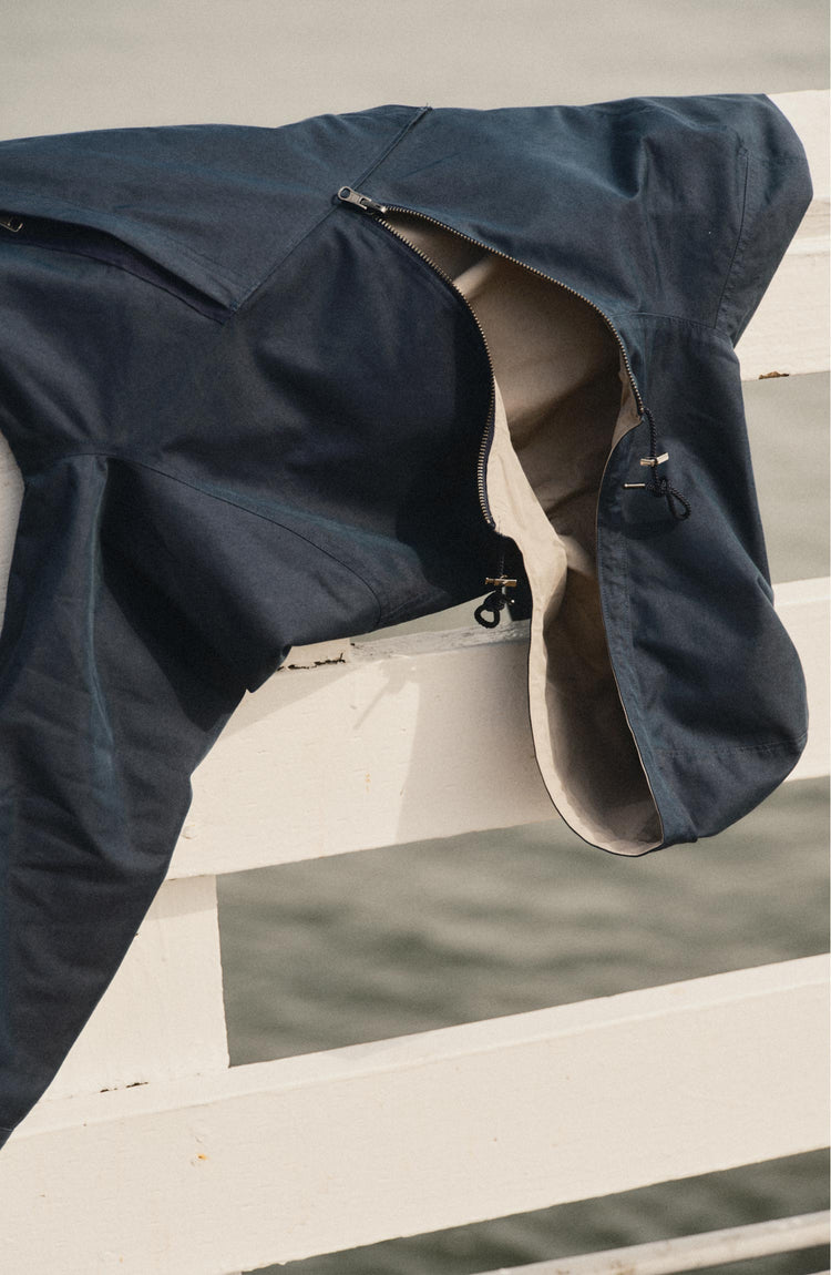 editorial image of The Squall Anorak in Navy Twill on a railing