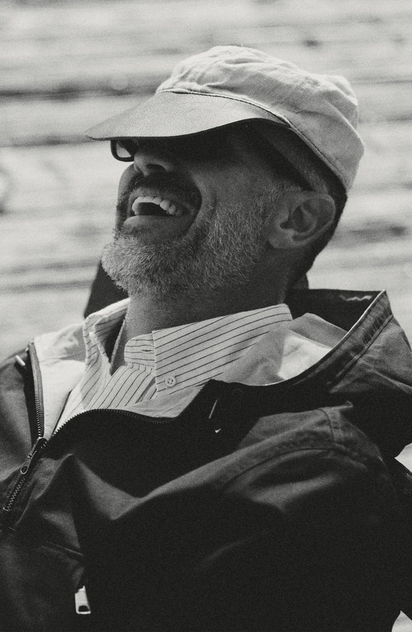 fit model laughing wearing The Squall Anorak in Navy Twill