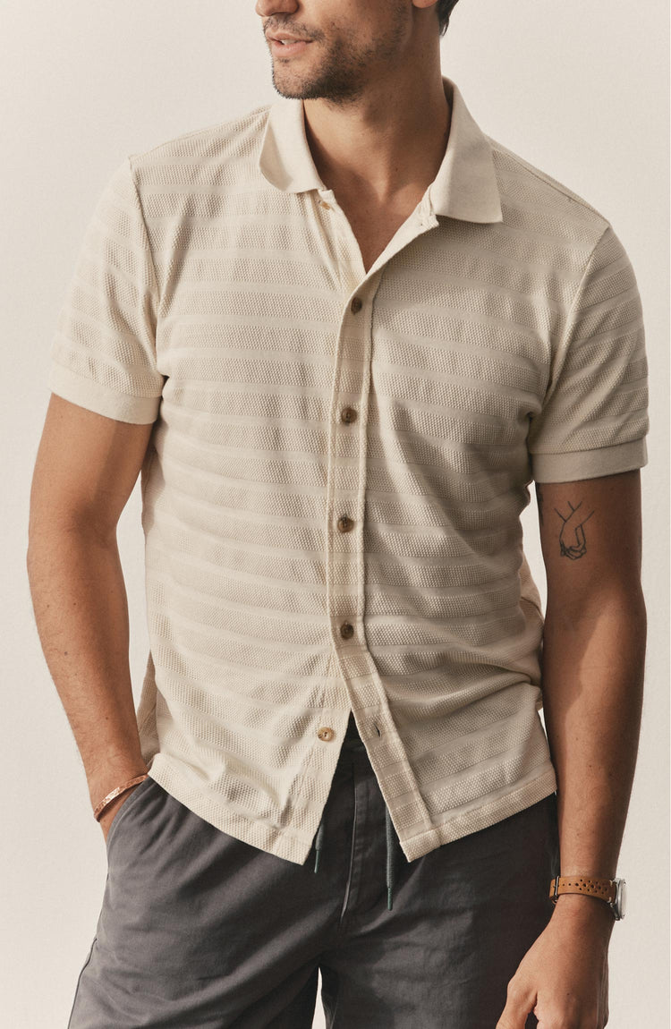 fit model posing in The Bywater Polo in Natural Knit Stripe