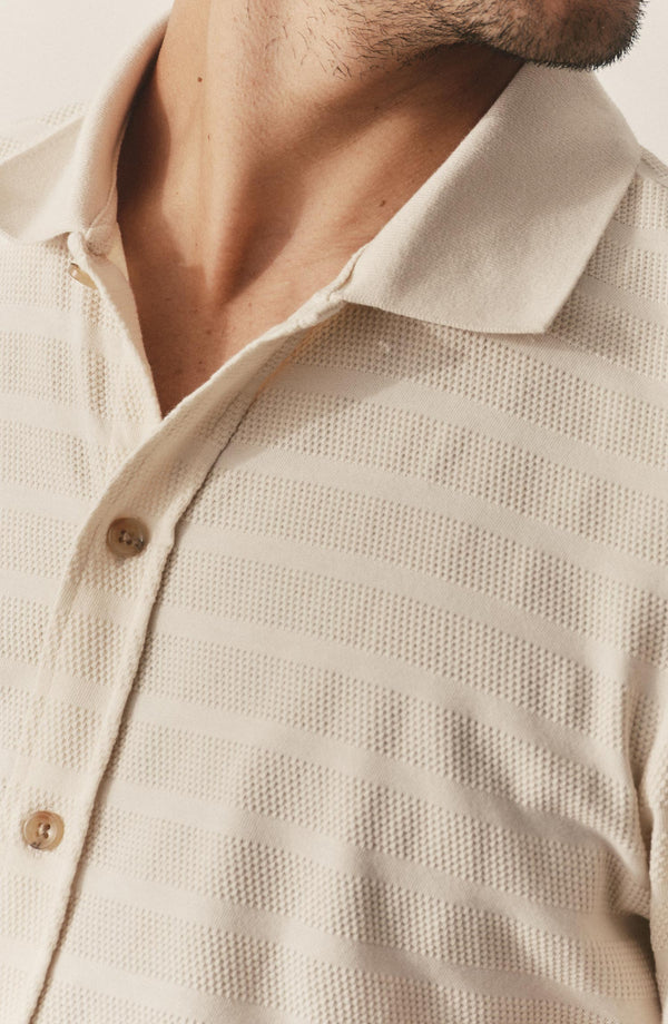 fit model showing off the buttons on The Bywater Polo in Natural Knit Stripe
