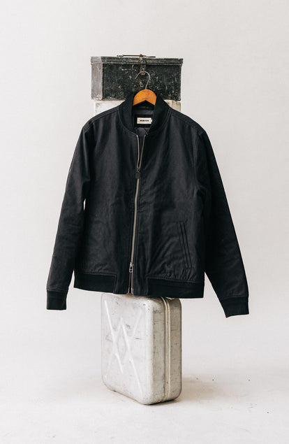 editorial image of The Bomber Jacket in Coal Dry Wax hanging