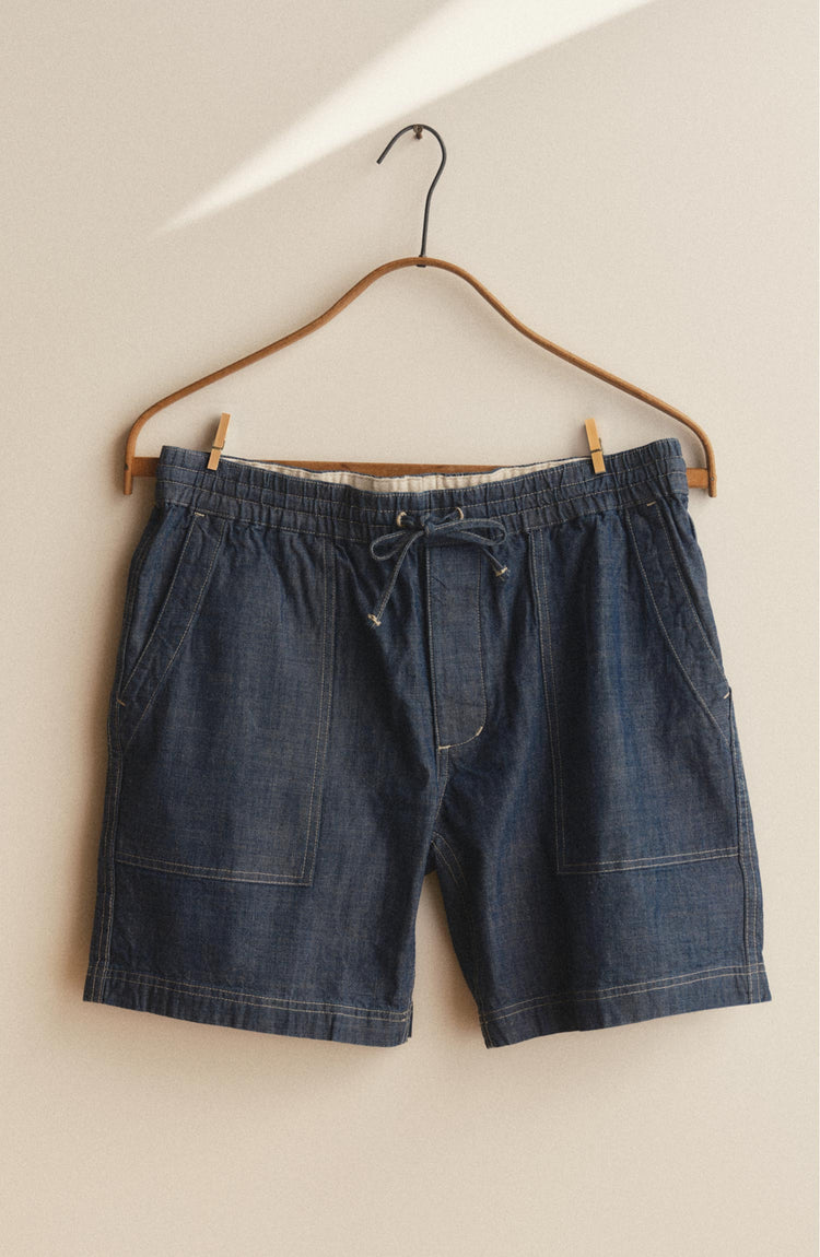 fit model walking wearing The Breakwater Short in Washed Indigo Chambray
