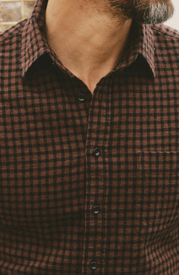 fit model showing off the buttons on The California Shirt in Black Cherry Gingham