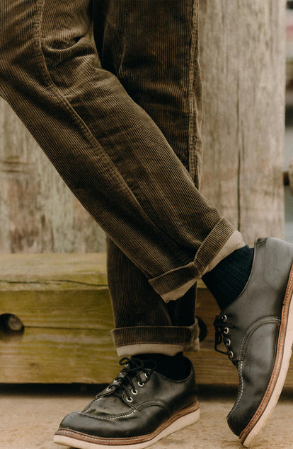 fit model showing off the hem on The Carnegie Pant in Fatigue Olive Corduroy