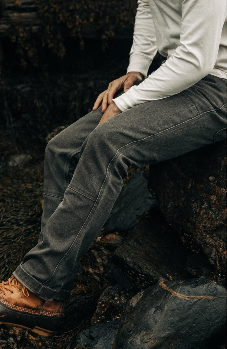 fit model sitting in The Chore Pant in Soil Chipped Canvas