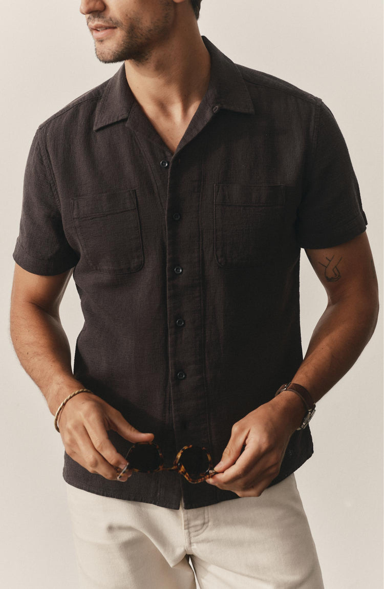 fit model posing in The Conrad Shirt in Faded Black Linen