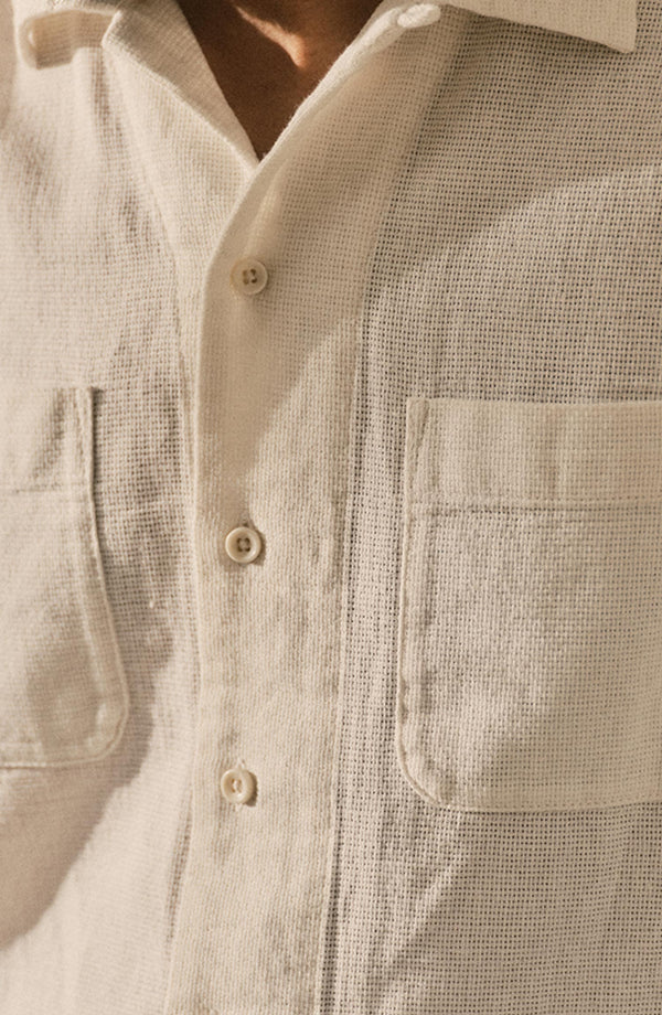 editorial flatlay of The Conrad Shirt in Vintage White Linen on a chair