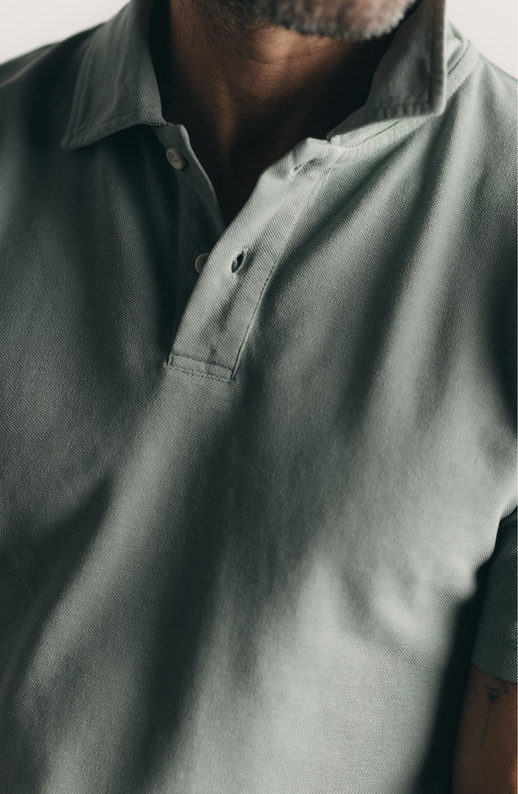 fit model posing in The Cotton Hemp Polo in Surf Green Pique