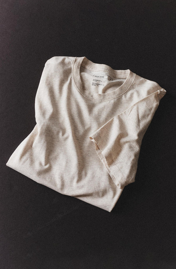 editorial flatlay of The Cotton Hemp Tee in Heather Oat folded