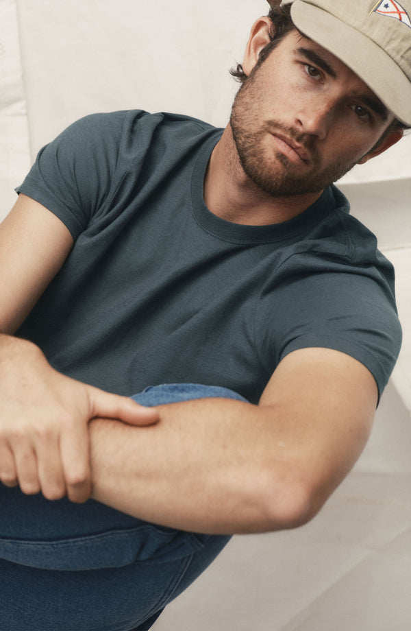 fit model sitting in The Cotton Hemp Tee in Navy