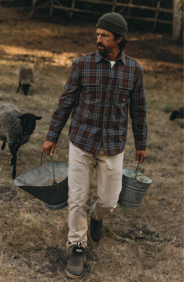 fit model walking wearing The Craftsman Shirt in Brick Plaid