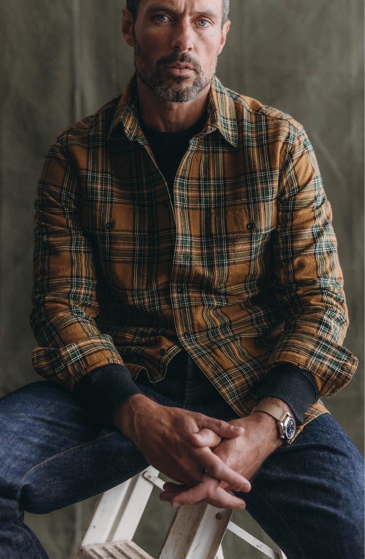 fit model sitting wearing The Craftsman Shirt in Fern Plaid