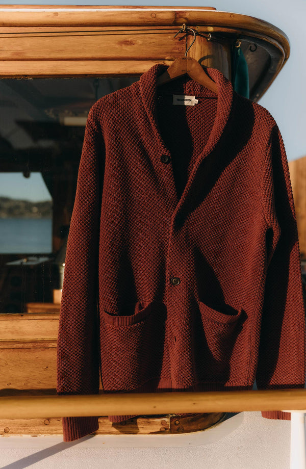 editorial image of The Crawford Sweater in Rust hanging