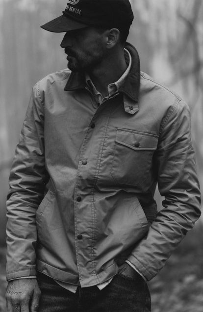 fit model with his hands in his pocket wearing The Deck Jacket in Khaki Dry Wax