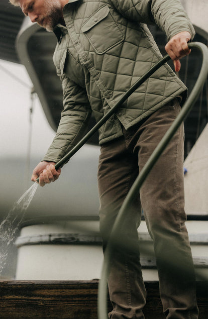 fit model using a hose wearing The Democratic 5-Pocket Pant in Fatigue Olive Corduroy