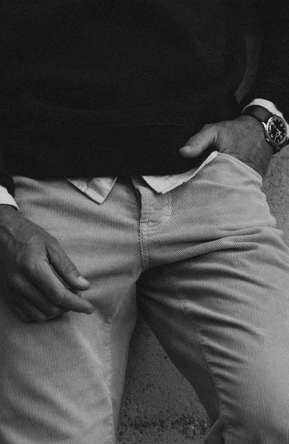 fit model with his hand in his pocket wearing The Democratic 5-Pocket Pant in Washed Khaki Corduroy