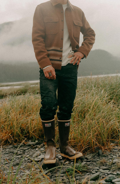 fit model with his hand on his hip wearing The Democratic Jean in Rigid Black Organic Selvedge