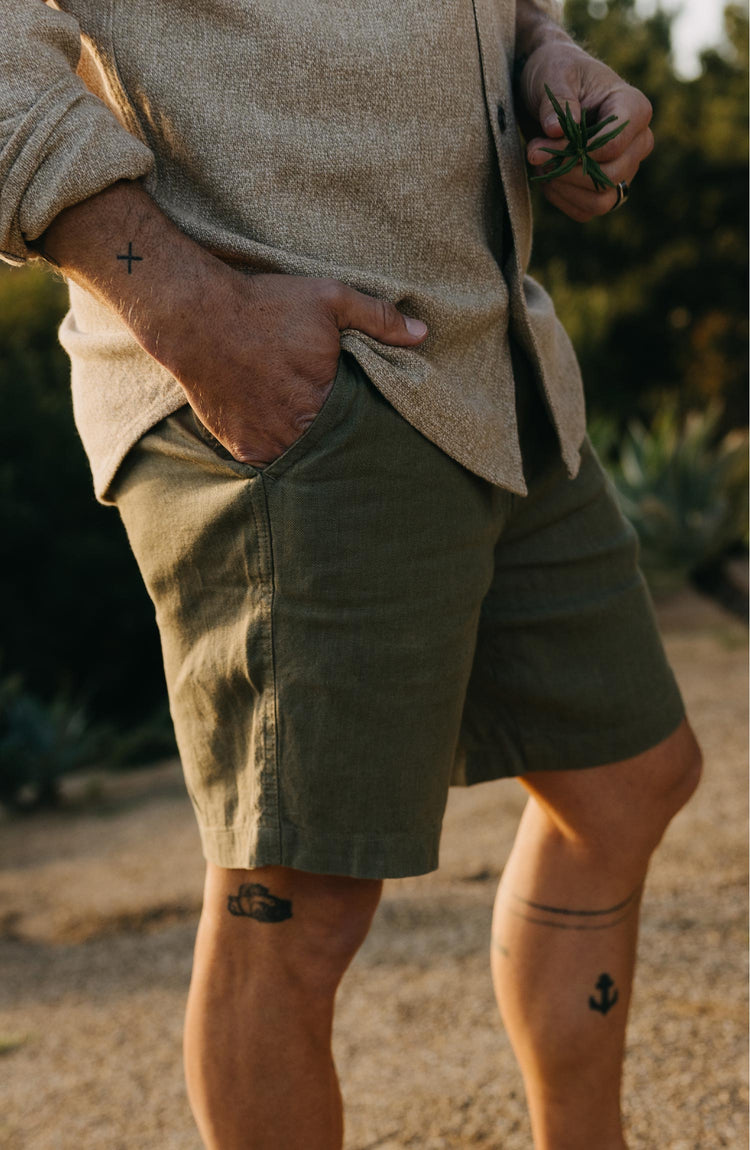 fit model with his hand in the pocket of The Easy Short in Olive Linen