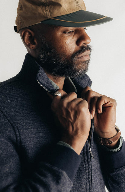 fit model adjusting the collar on The Evans Jacket in Navy Birdseye Wool