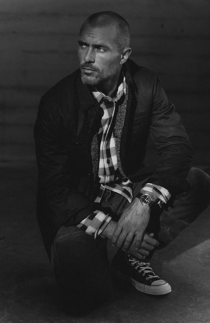 fit model crouching wearing The Fender Jacket in Coal Dry Wax