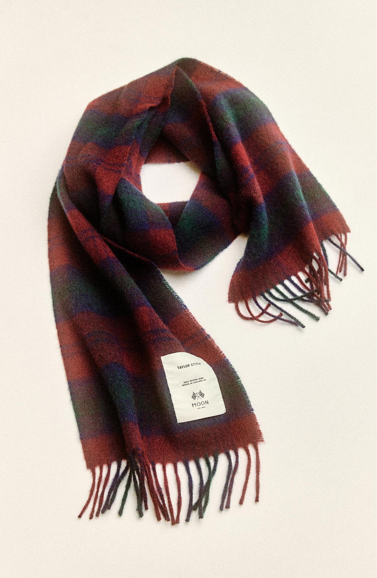 editorial flatlay of The Fireside Scarf in Currant Plaid