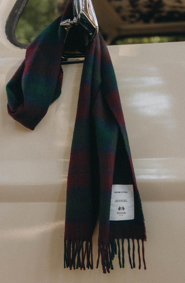 editorial image of The Fireside Scarf in Currant Plaid hanging on a car