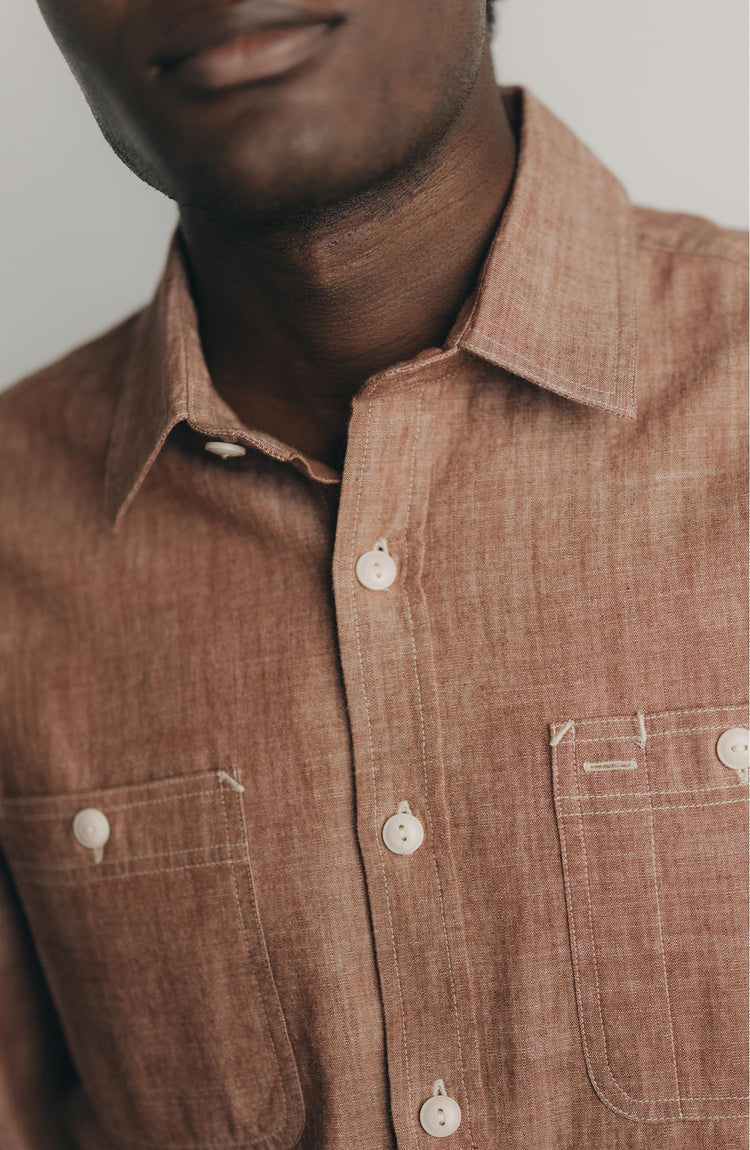 fit model posing in The Foundry Shirt in Brick Chambray