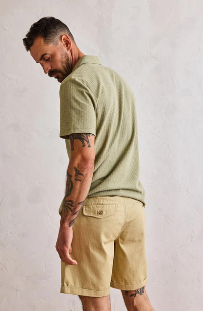 fit model showing off the back of The Herringbone Polo in Heather Sage