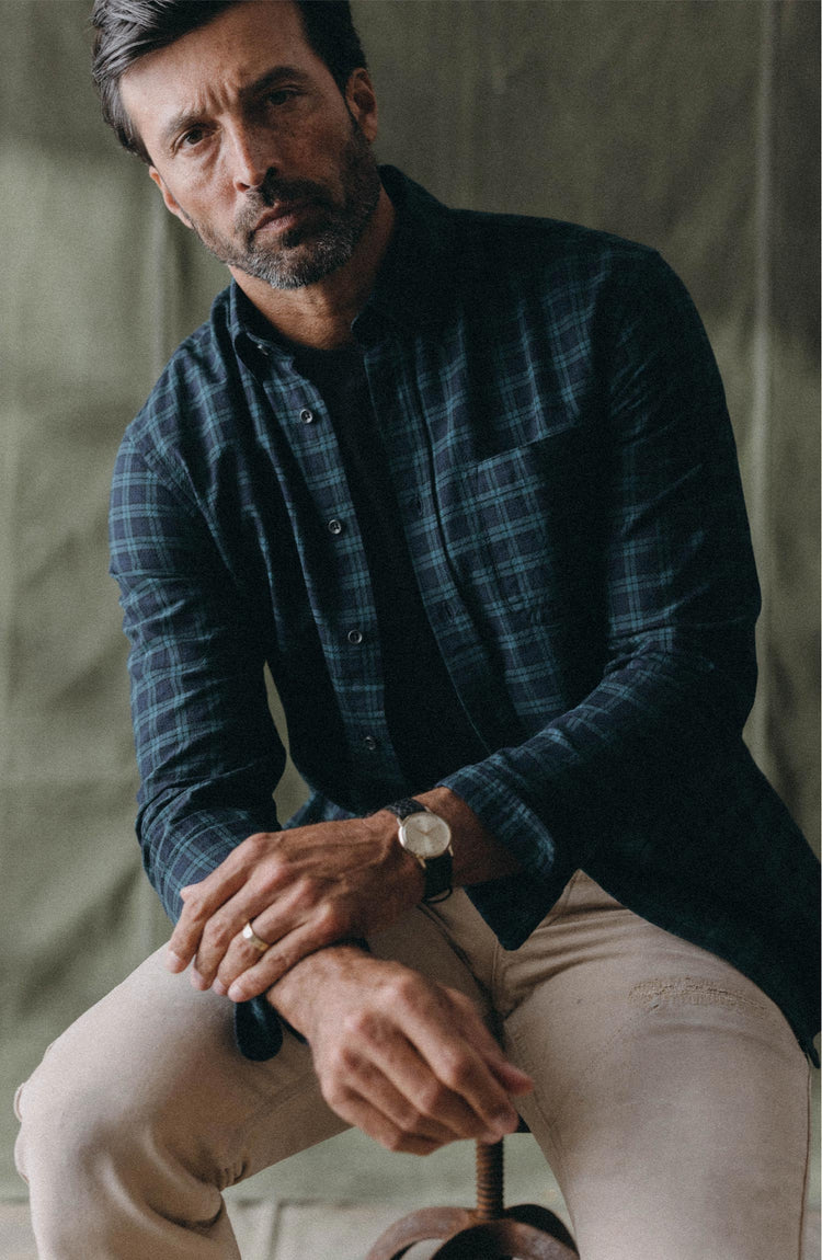 fit model sitting wearing The Jack in Blackwatch Plaid