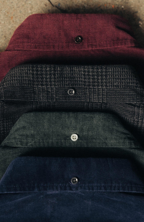 material shot of the back collar of The Jack in Heather Coal Check Pincord next to other shirts