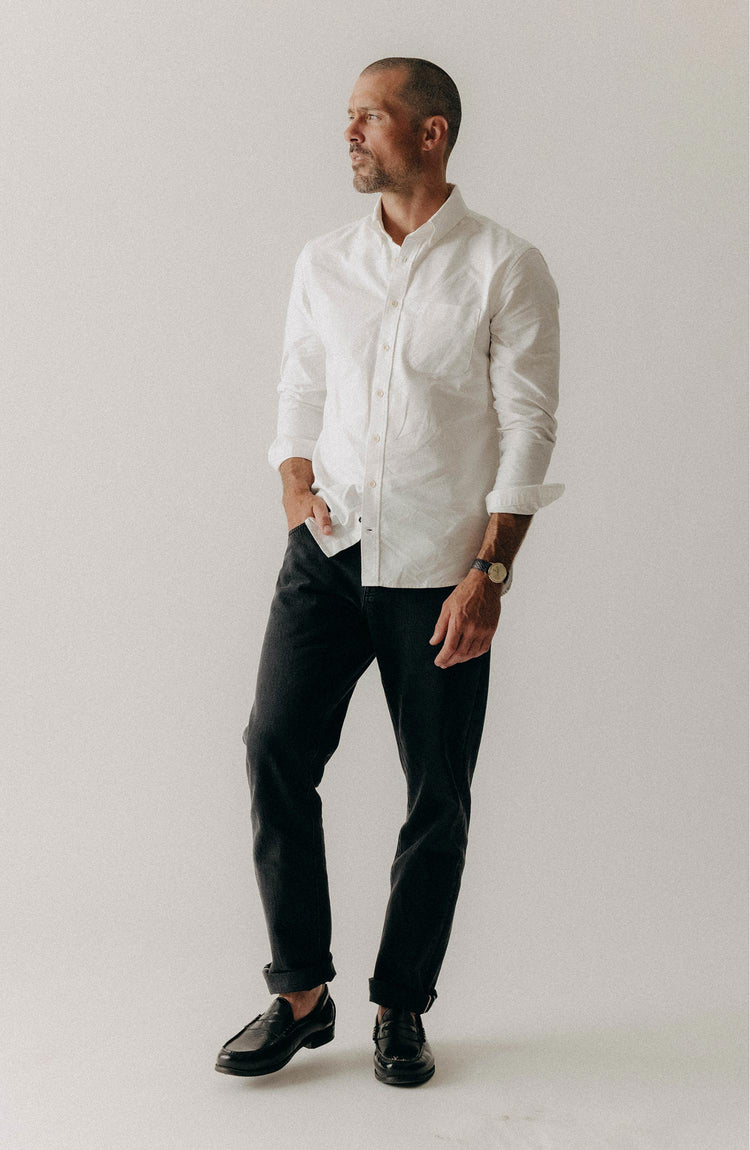 fit model putting a jacket on over The Jack in White Everyday Oxford
