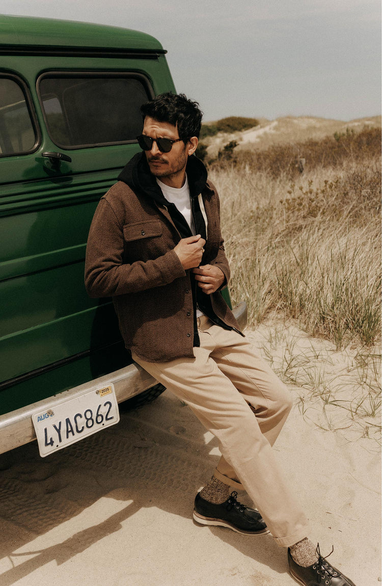 fit model leaning against a car wearing The Ledge Shirt in Black Coffee Linen Tweed