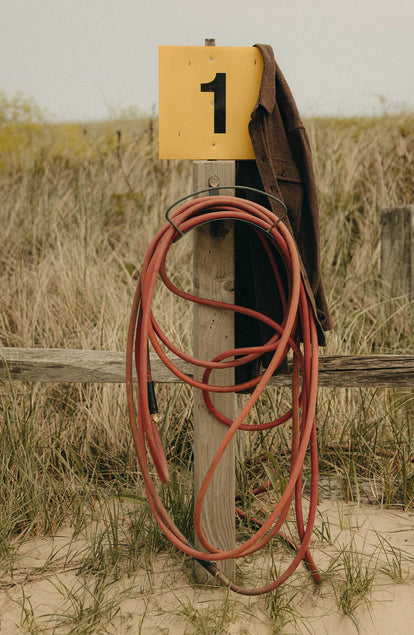 editorial image of The Ledge Shirt in Black Coffee Linen Tweed hanging on a post