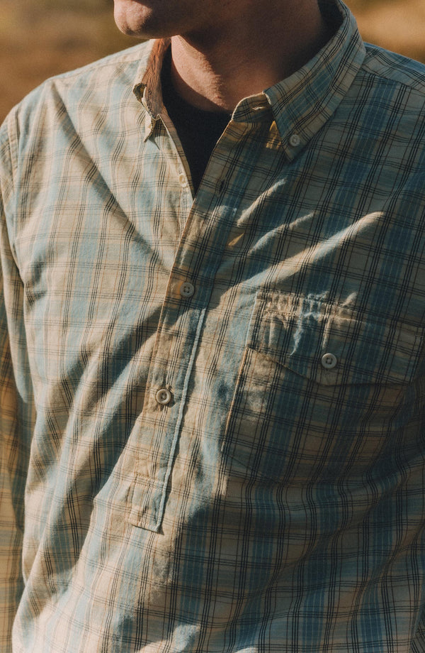 fit model showing off the buttons on The Logan Popover in Blue Sky Plaid