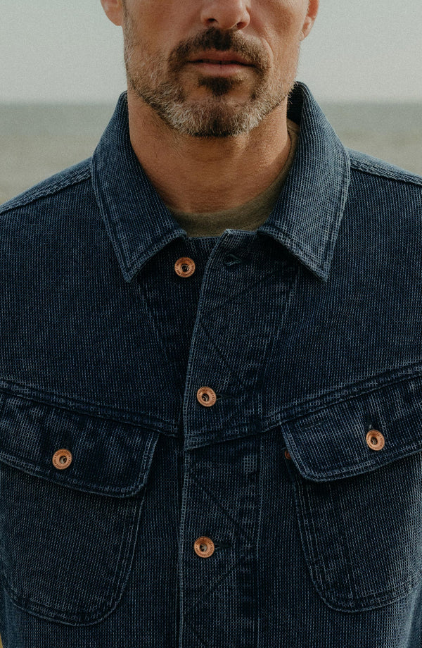 Our model standing in the long haul jacket in indigo waffle