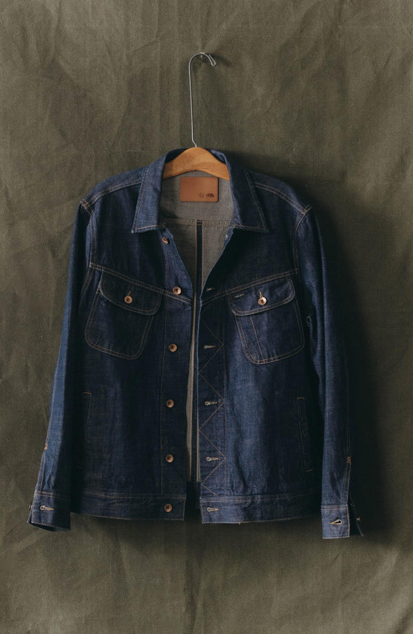 editorial image of The Long Haul Jacket in Rinsed Organic Selvedge next to a book