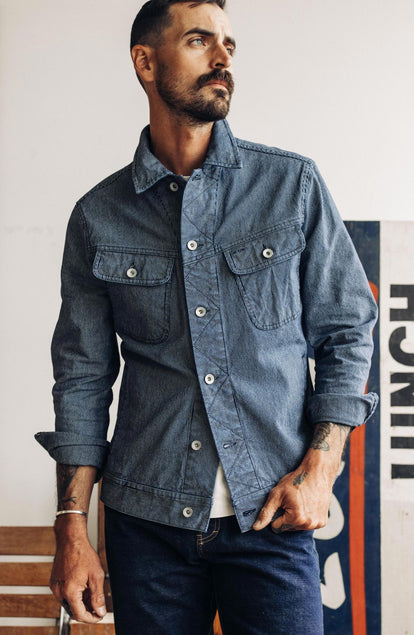 Our model standing in the long haul jacket in washed indigo stripe