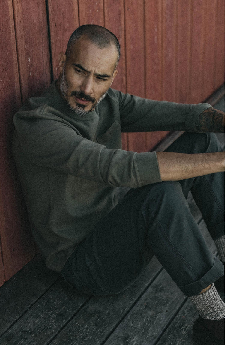 fit model posing in The Long Sleeve Shop Tee in Army Twist