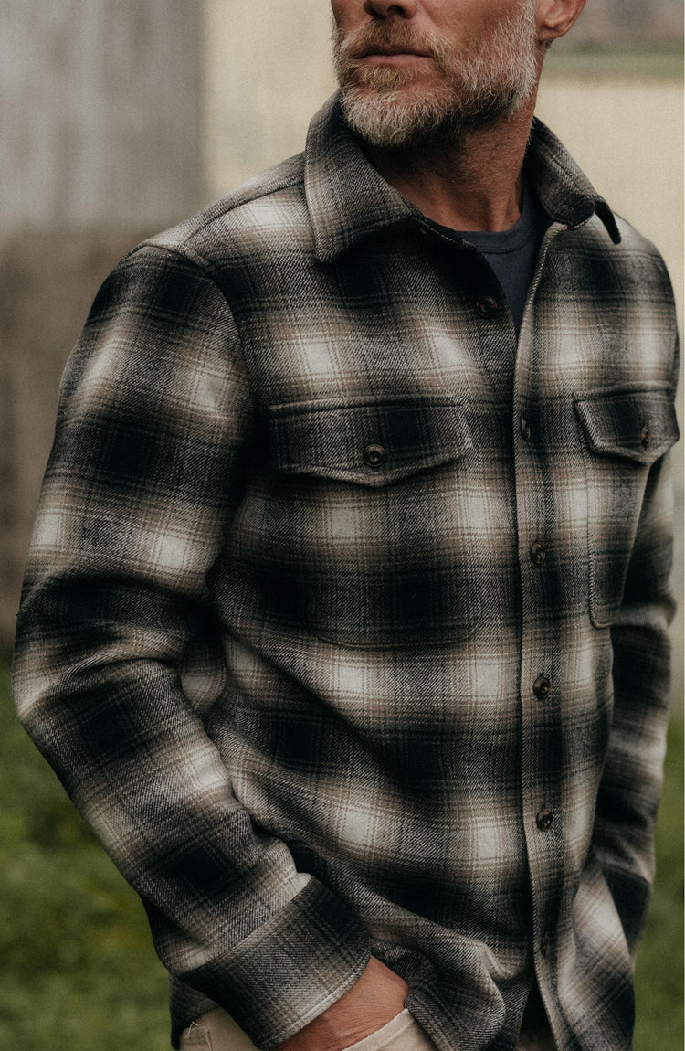 fit model standing wearing The Maritime Shirt Jacket in Olive Plaid