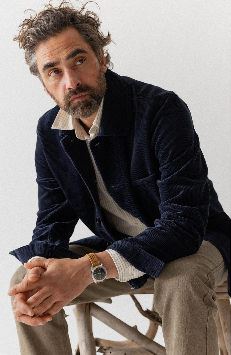 fit model sitting wearing The Ojai Jacket in Dark Navy Corduroy