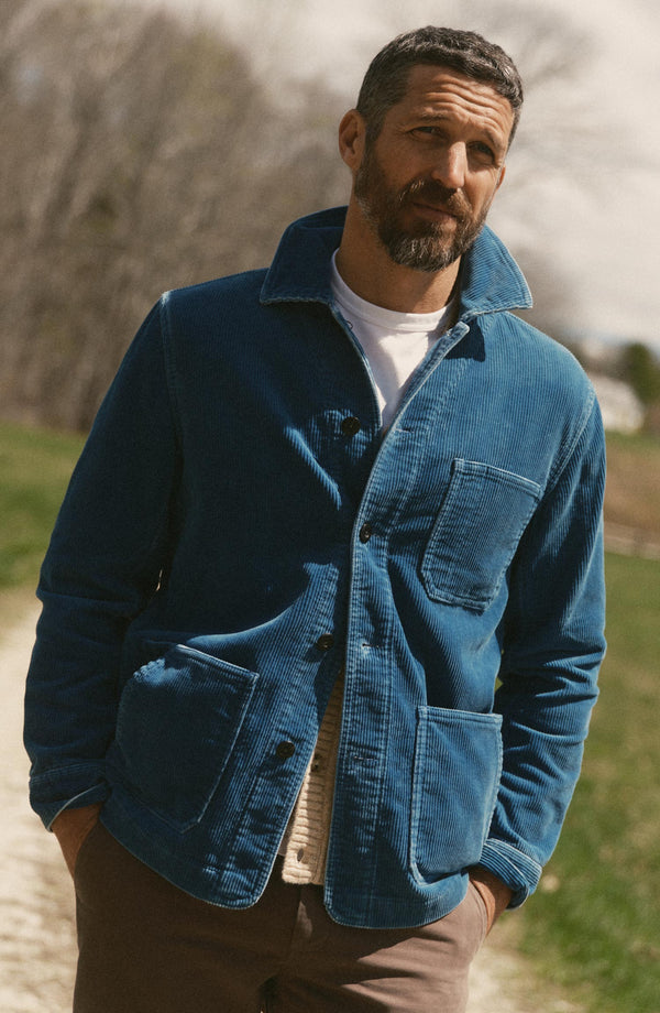 fit model with his hands in his pockets wearing The Ojai Jacket in Washed Indigo Corduroy